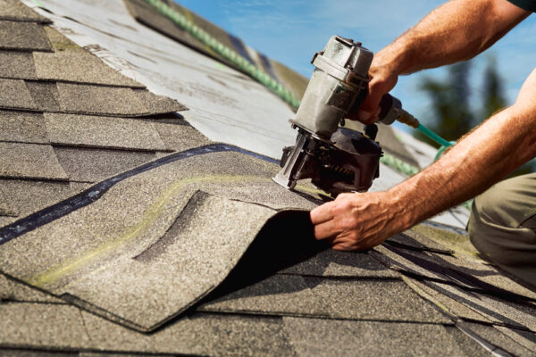nail gun on roofing shingle
