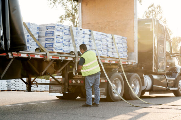truck driver loading bed of truck
